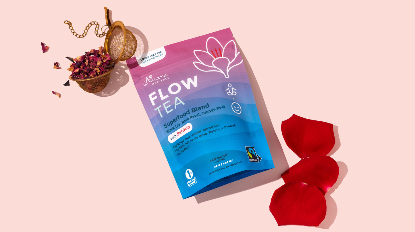Flow Tea package with red flower petals on a pink background
