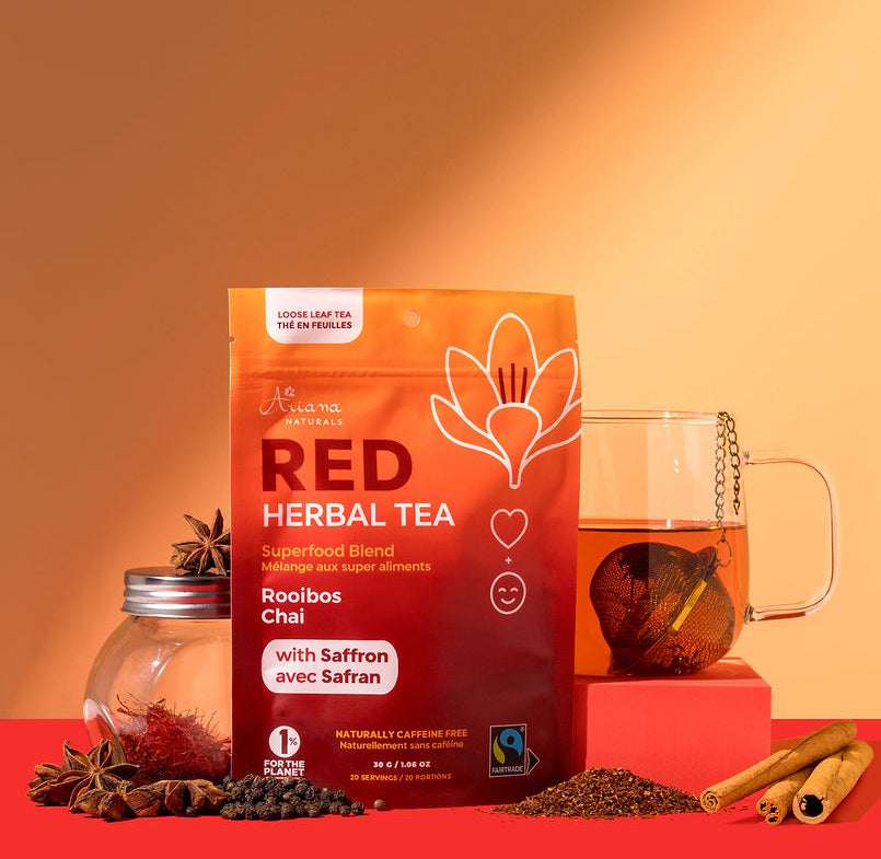 Red herbal tea package with a cup of tea and it's ingredient's, Rooibos, Star Anise, Black Pepper, Cinnamon Sticks, and Saffron, on an orange and red background.