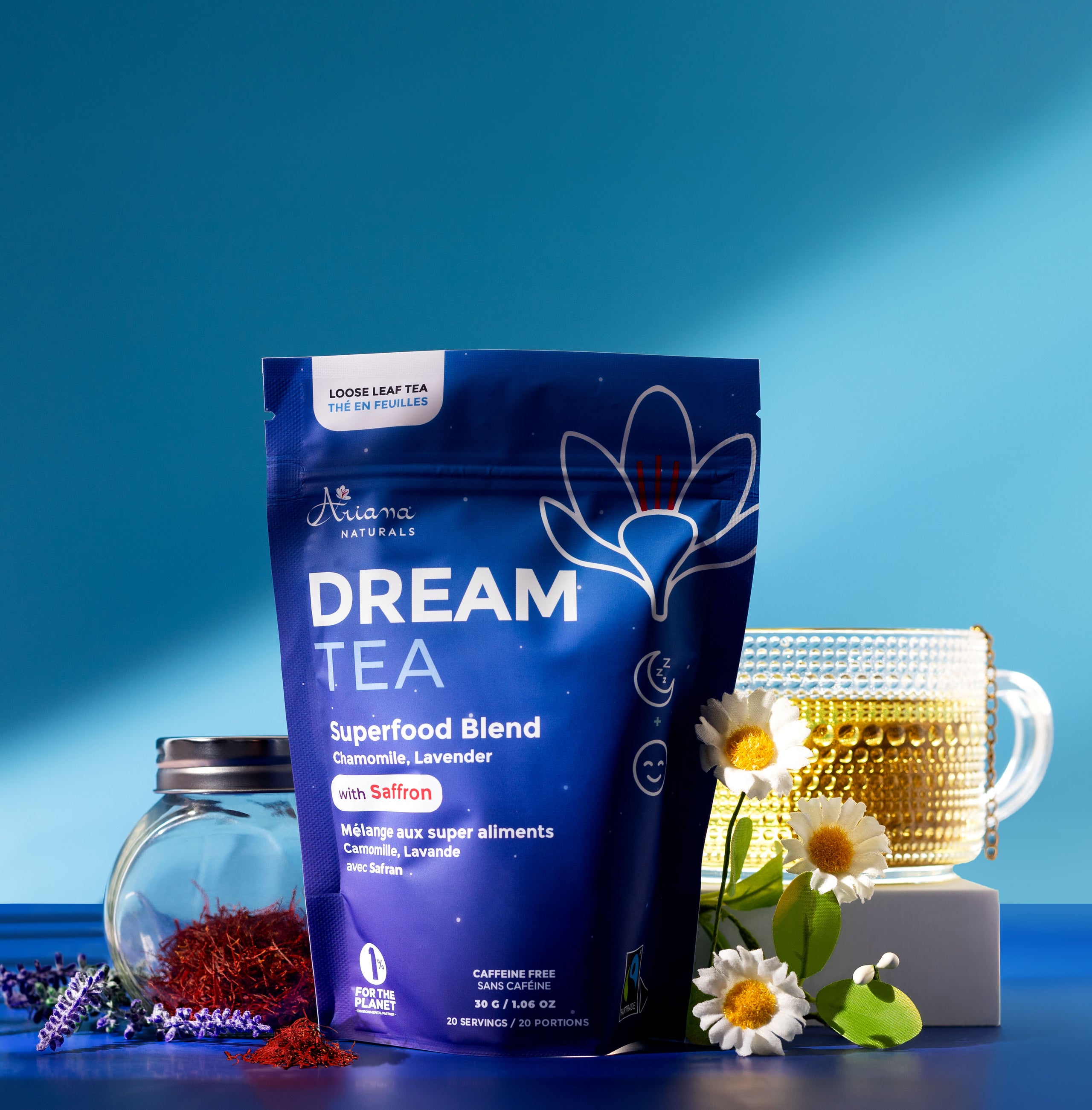 Ariana Naturals Dream Tea packaging with a cup of tea, and it's whole ingredients, Chamomile flowers, Lavender and Saffron on a multi blue background.